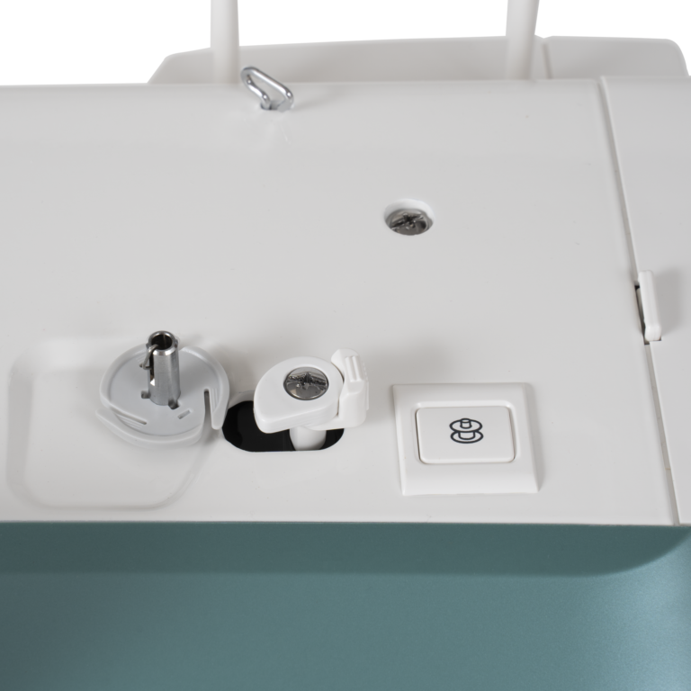 Janome Continental M6 sewing & quilting machine top view, white with teal base and visible bobbin area