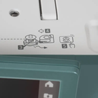 Janome Continental M6 sewing and quilting machine, teal housing with white top panel and instruction icons