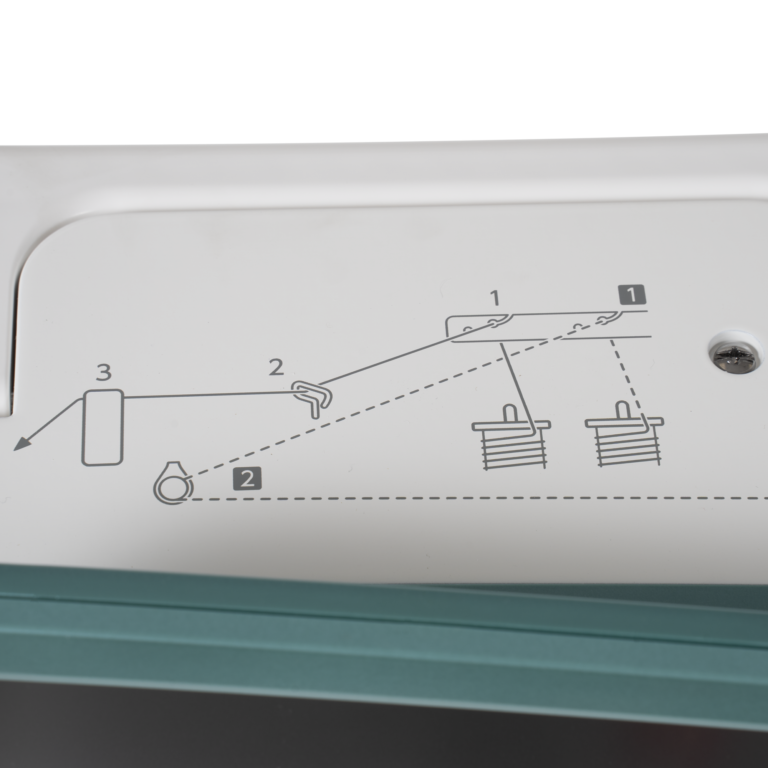 Janome Continental M6 sewing machine panel with instruction diagram, white body and teal base.