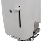 White sewing machine side panel with vertical tension slot and pedal visible