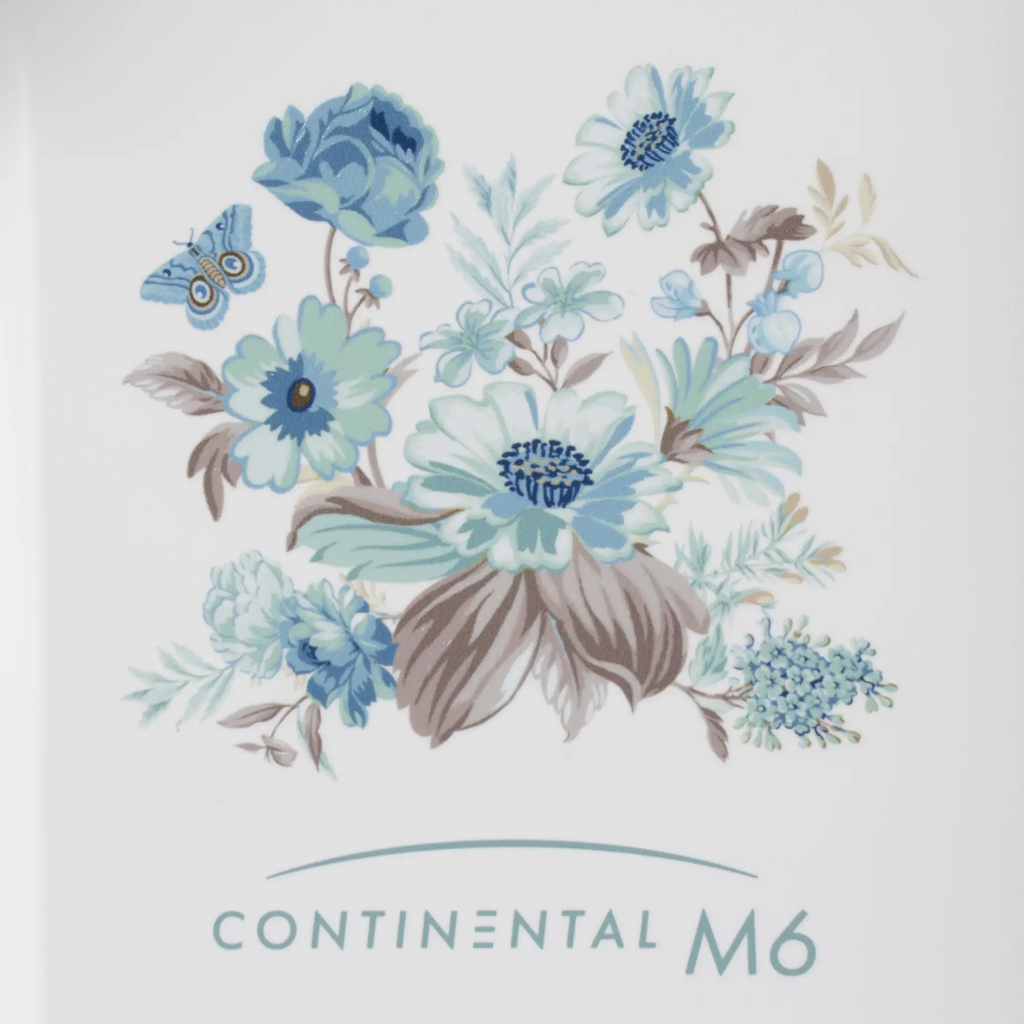 Janome Continental M6 sewing machine cover with blue floral bouquet on white background