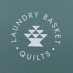 Laundry Basket Quilts logo on teal background, circular text around a geometric white emblem.