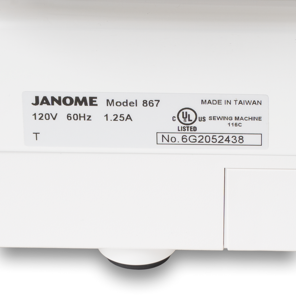 Janome sewing machine label on a white box showing Model 867, made in Taiwan, UL listed.
