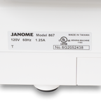 Janome sewing machine label on a white box showing Model 867, made in Taiwan, UL listed.