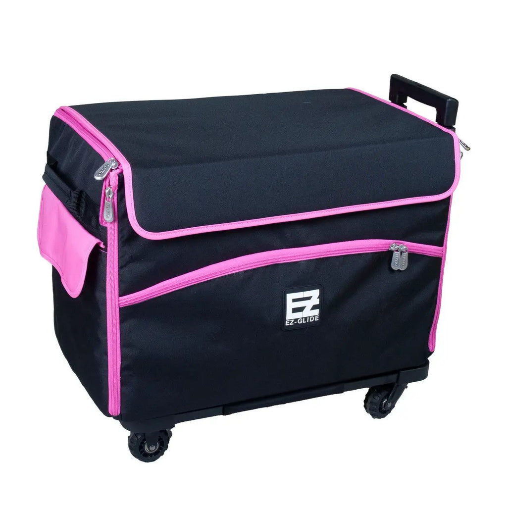 21in EZ-Glide Trolley sewing bag in black with pink trim, four wheels, top retractable handle, EZ-Glide logo visible.