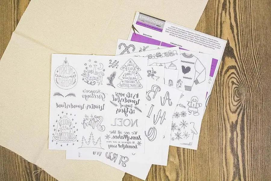 Threaders Embroidery Transfer Sheets – Festive; three white sheets with black designs