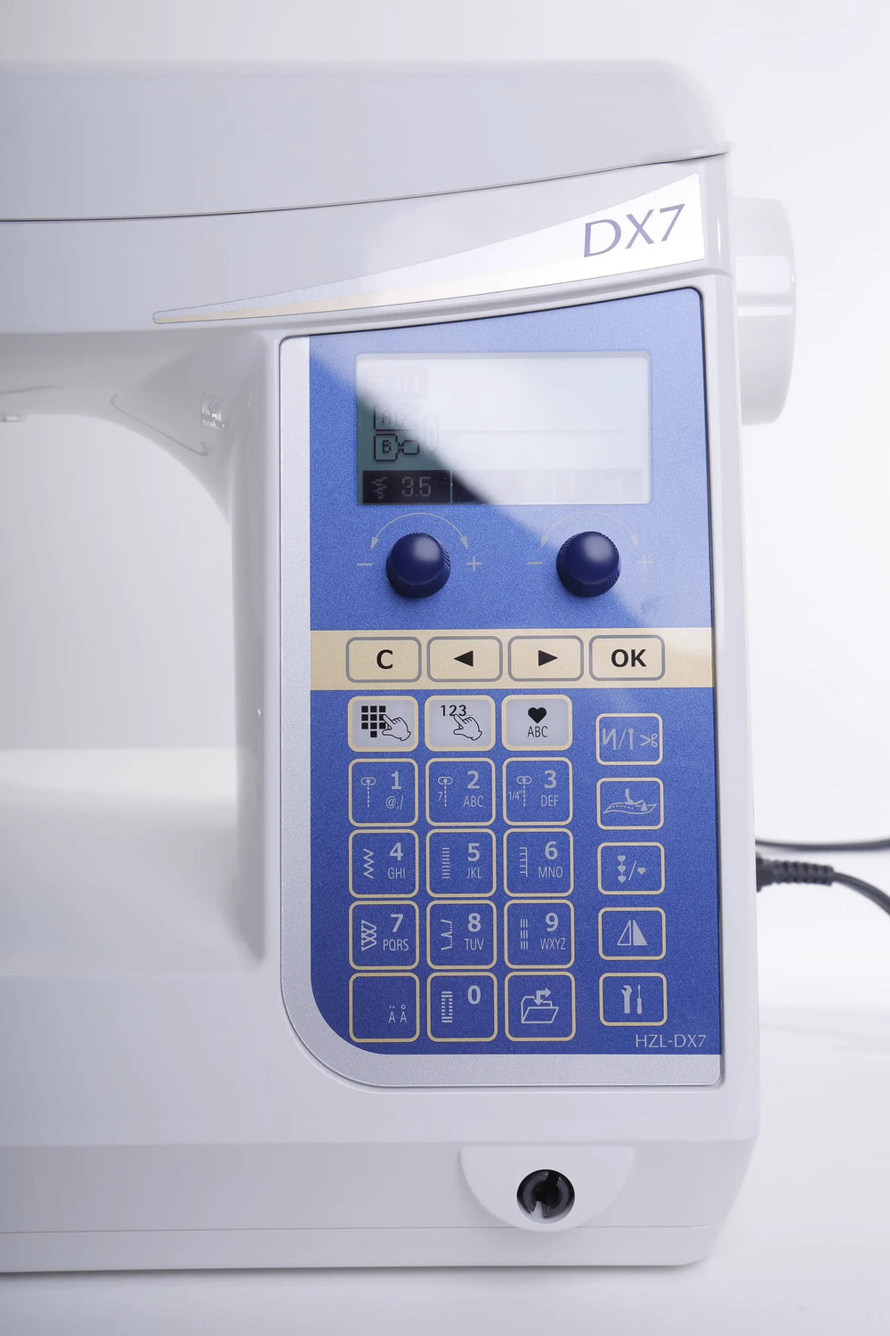 Juki HZL-DX7 computerized sewing machine with blue control panel and keypad