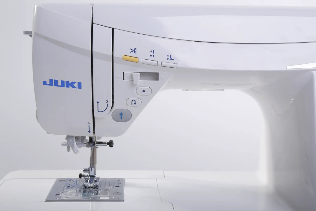 Juki HZL-DX7 sewing machine, white computerized model with blue JUKI logo and front control panel.
