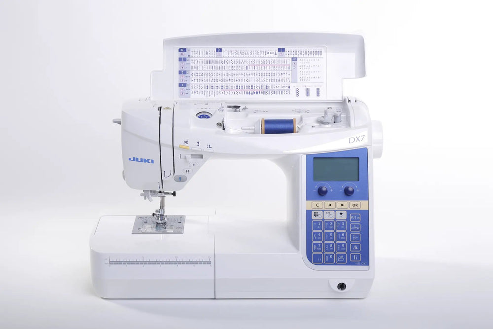 Sewing machine Juki HZL-DX7, white computerized model with blue control panel and open bobbin area.