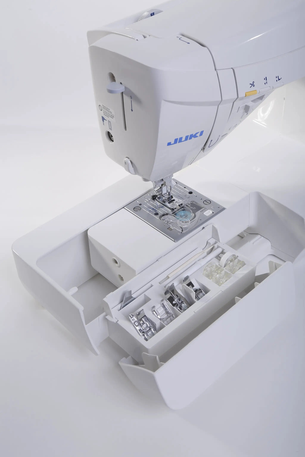 Juki HZL-DX7 computerized sewing machine with white housing, blue Juki logo, and visible accessory storage drawers.