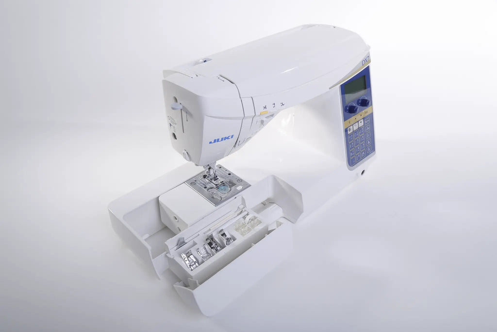 Juki HZL-DX7 white computerized sewing machine with blue control panel and LCD screen.