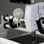 HQ Handi Fan by Handi Quilter; white circular fan accessory mounted on a quilting machine.