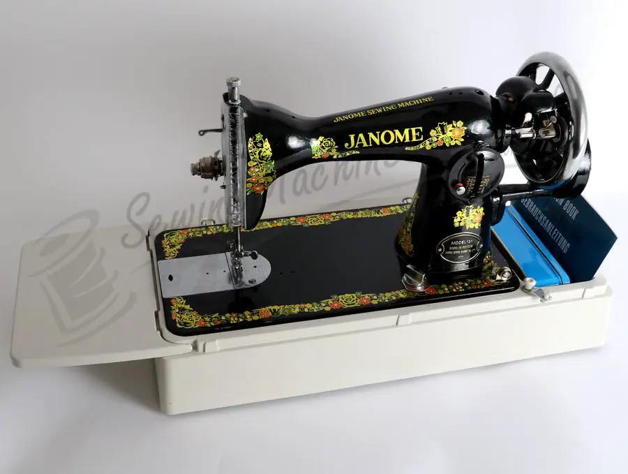 Janome 131HDL hand-crank sewing machine, black with gold floral detailing on a white base.