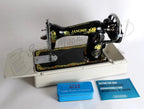 Janome 131HDL hand-crank sewing machine on white treadle base with floral decals