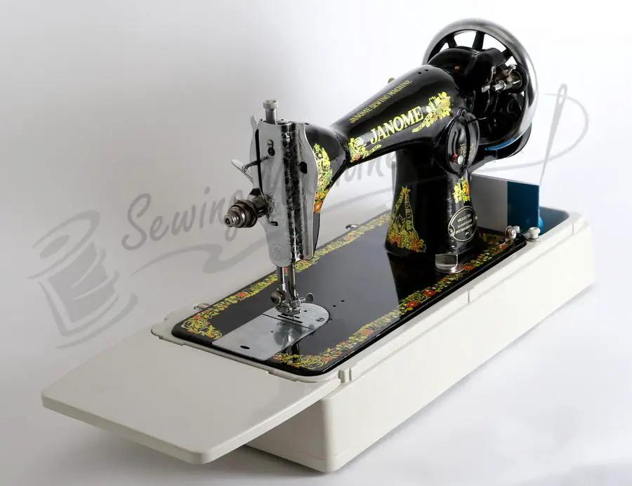 Janome 131HDL hand-crank sewing machine with ornate black body and gold trim on a white extendable table.