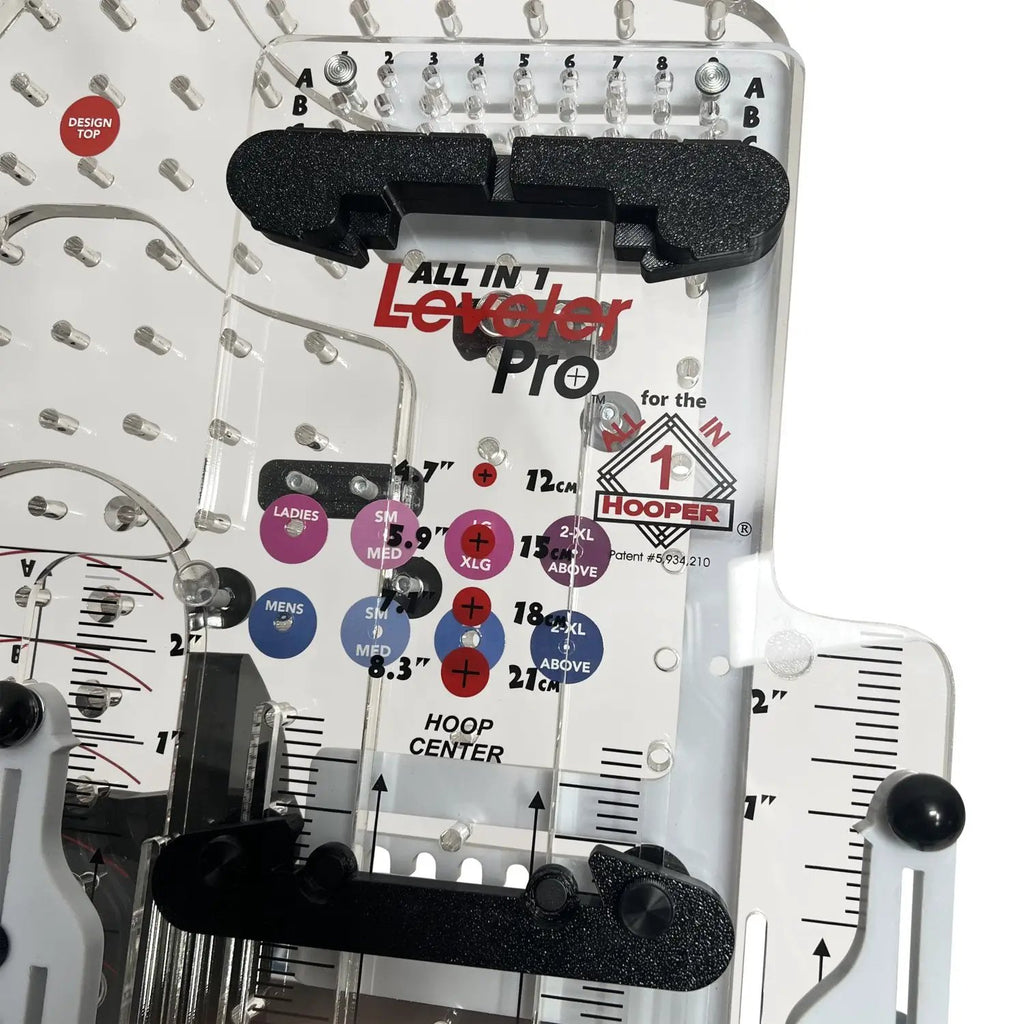 All in 1 Leveler Pro hooping station with black foam alignment bars on a white panel featuring measurement rulers.