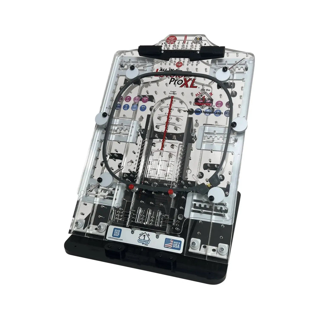 All in 1 Leveler Pro XL hooping station by Tex Inc; clear acrylic construction with metal pegs and black base.