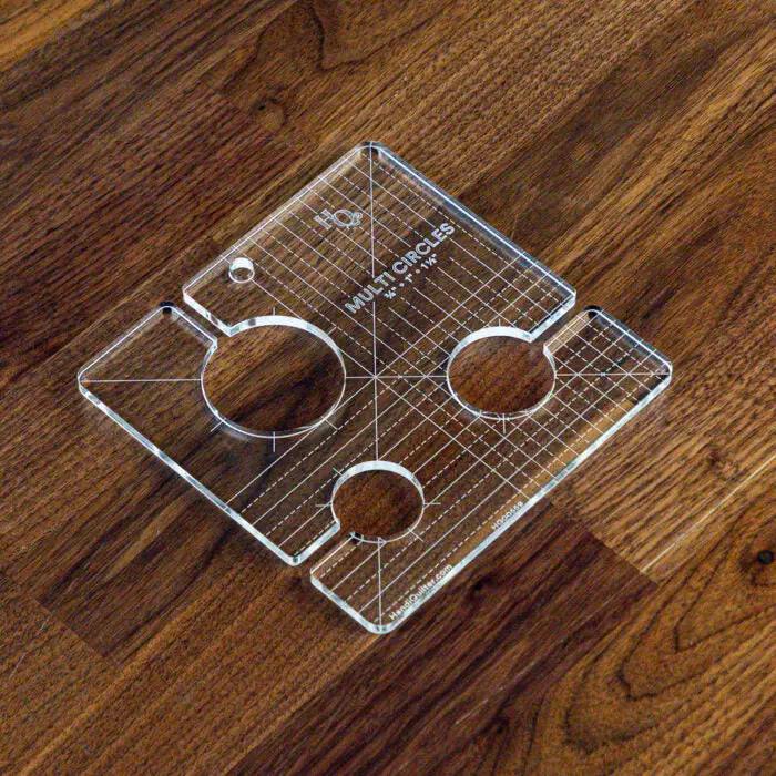Handi Quilter Multi Circles Ruler, clear acrylic quilting ruler with multiple circular cutouts and grid markings.