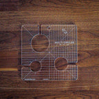 Handi Quilter Multi Circles quilting ruler; clear acrylic with grid lines and circular cutouts.