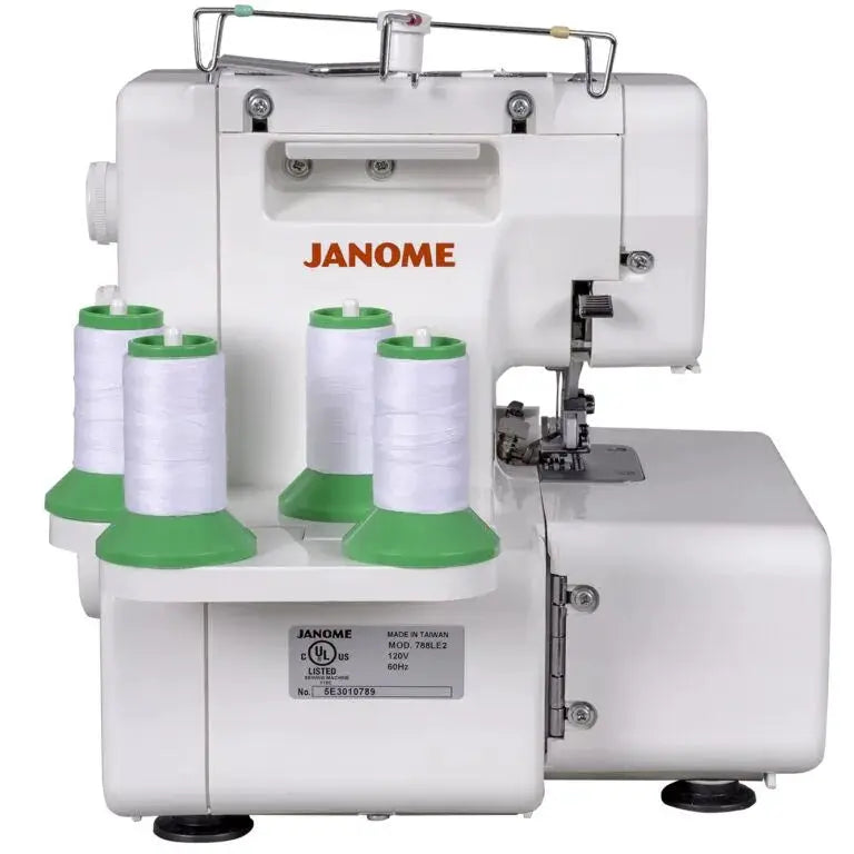 Janome MyLock 654D serger; white sewing machine with four white thread spools on green bases.
