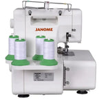 Janome MyLock 654D serger; white sewing machine with four white thread spools on green bases.