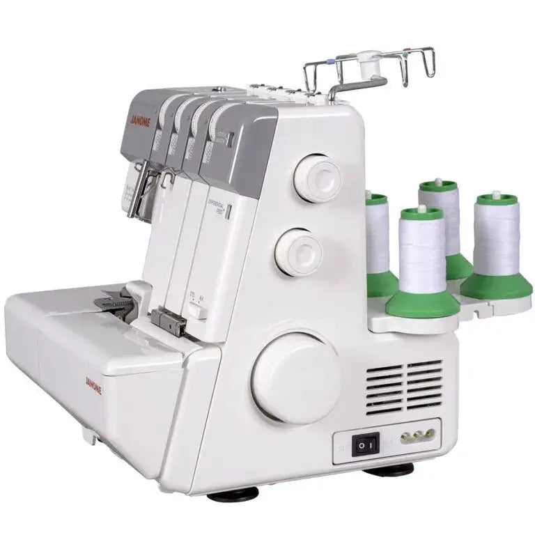 Janome MyLock 654D serger in white with four green-spool thread holders and large side knobs