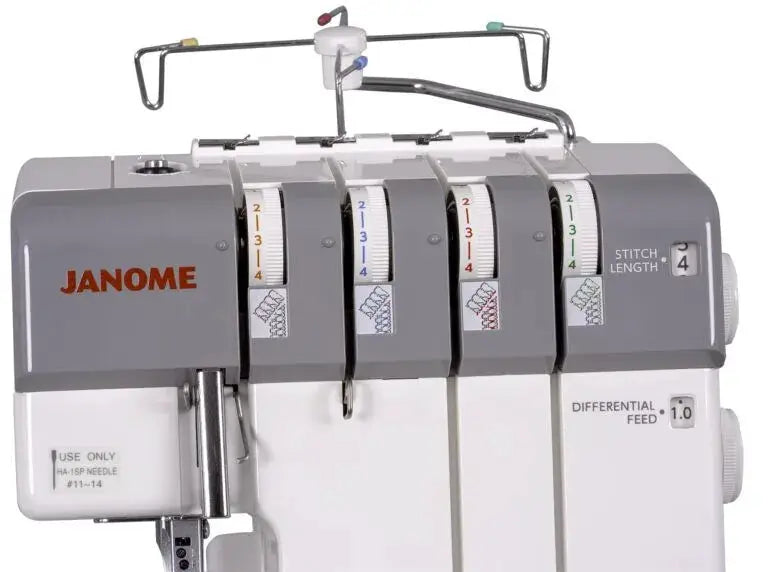 Janome MyLock 654D serger in gray with four thread spools and prominent JANOME logo