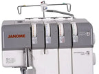 Janome MyLock 654D serger in gray with four thread spools and prominent JANOME logo
