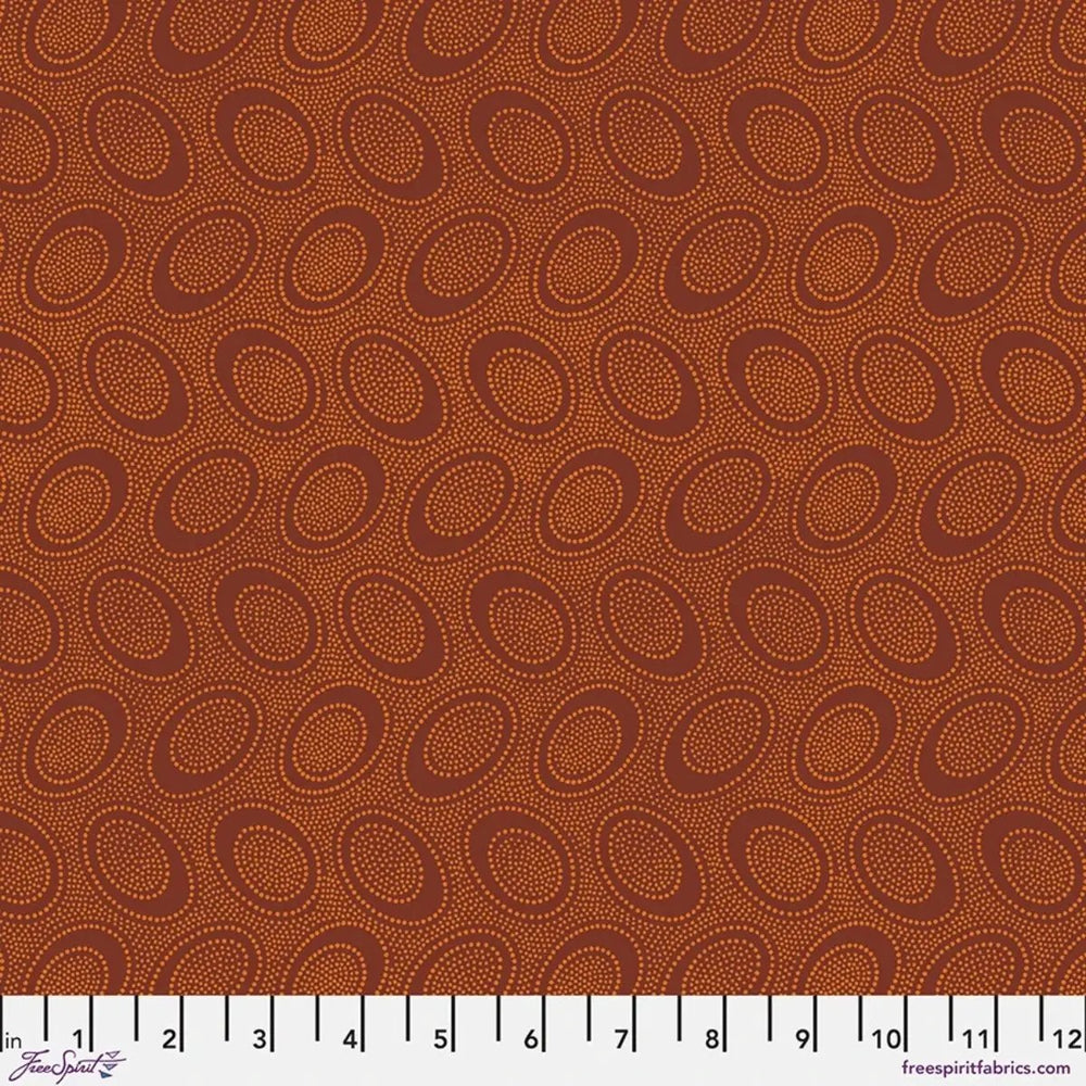 Kaffe Fassett Aboriginal Dot Pumpkin quilting cotton fabric with dotted circular motifs on a warm pumpkin-orange background.