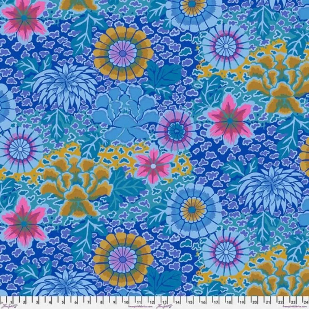 Dream Blue quilting cotton fabric with vibrant pink, purple, mustard, aqua, and blue flowers on a patterned blue background.