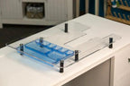 Handi Quilter extension table for HQ Stitch 710 machine; clear acrylic surface with blue accessory tray