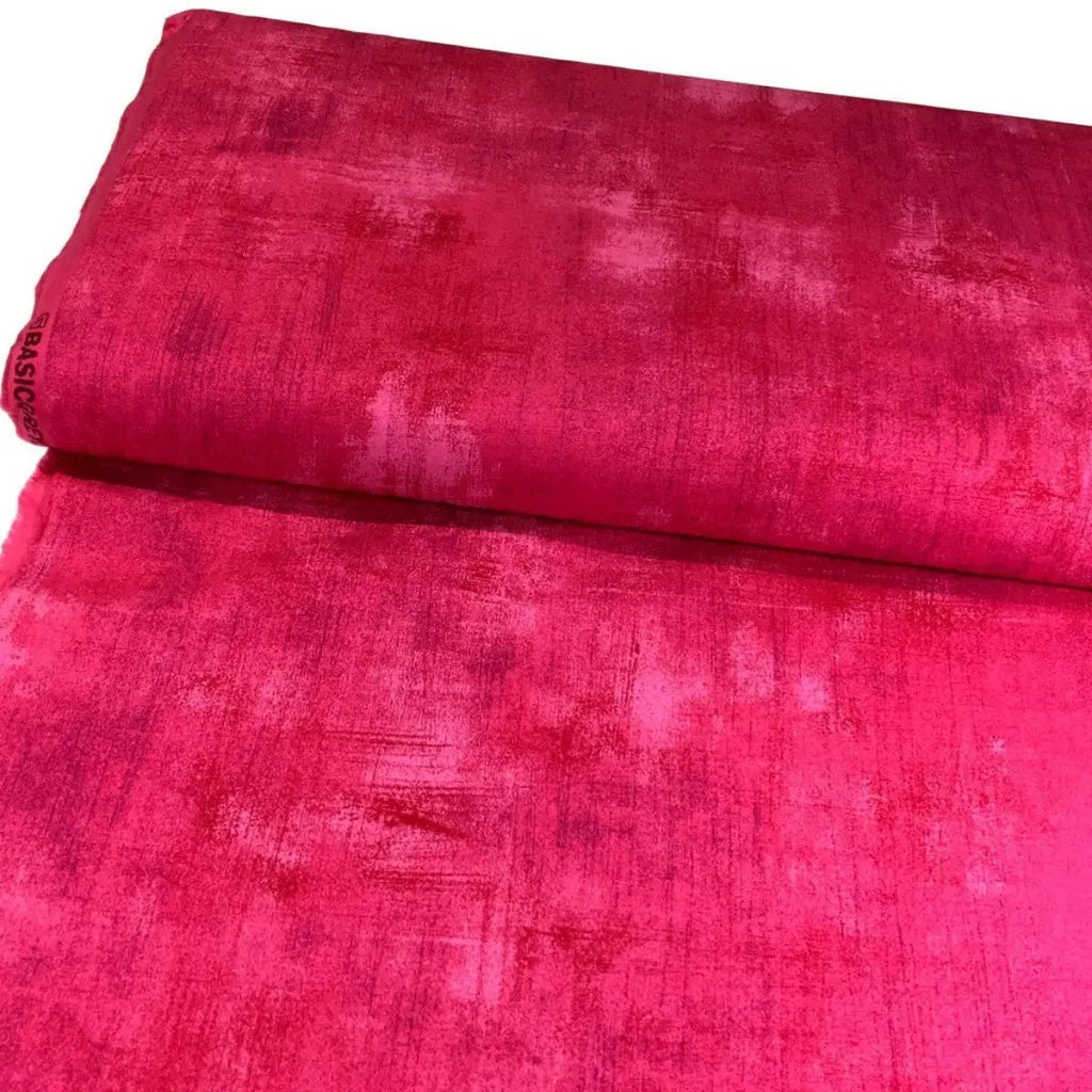 Folded Moda Grunge Basics Paradise Pink cotton quilting fabric showing its vibrant pink color and textured finish.