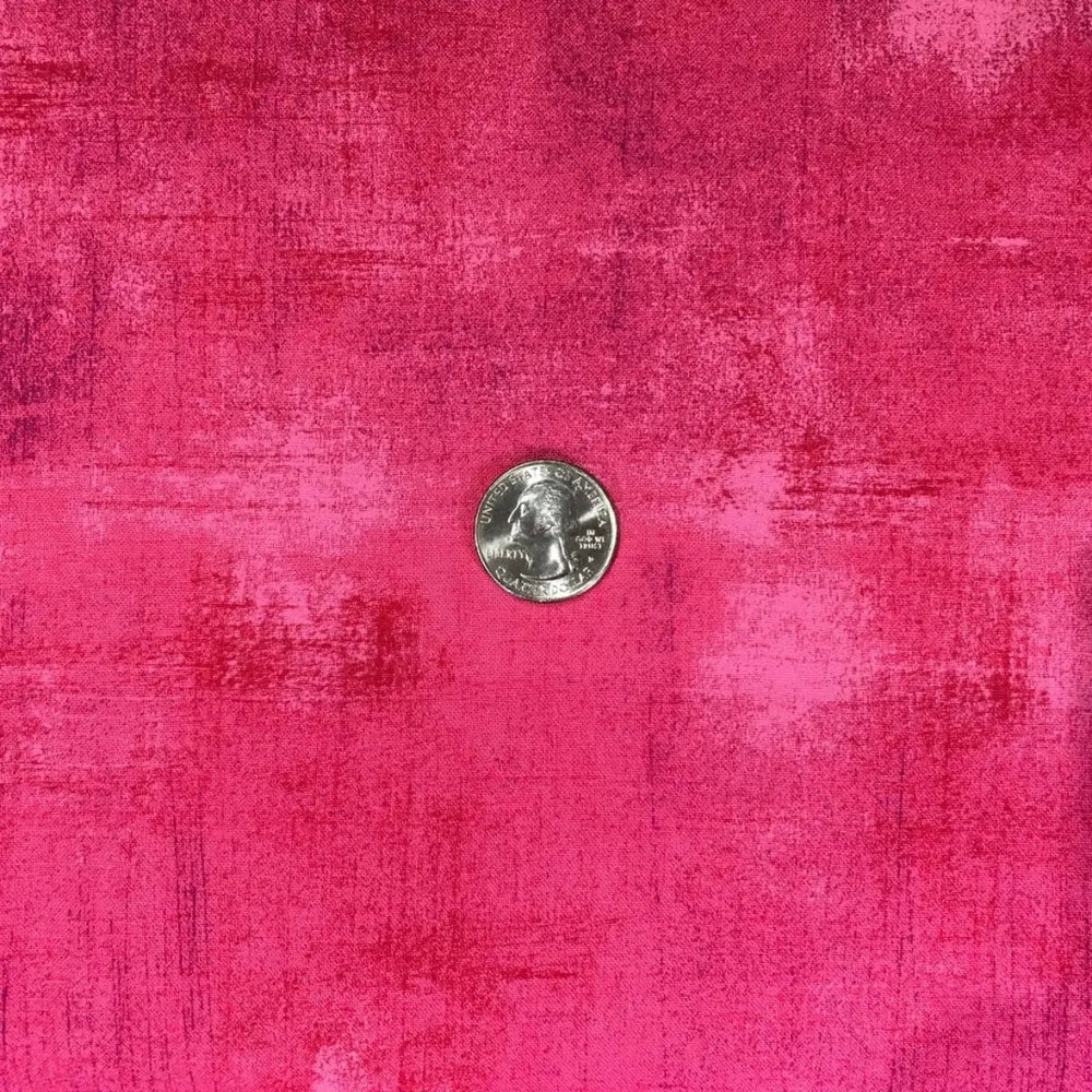 Close-up of Moda Grunge Basics Paradise Pink fabric featuring tonal pink markings and a measurement reference.