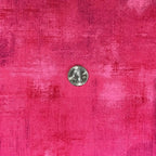 Close-up of Moda Grunge Basics Paradise Pink fabric featuring tonal pink markings and a measurement reference.