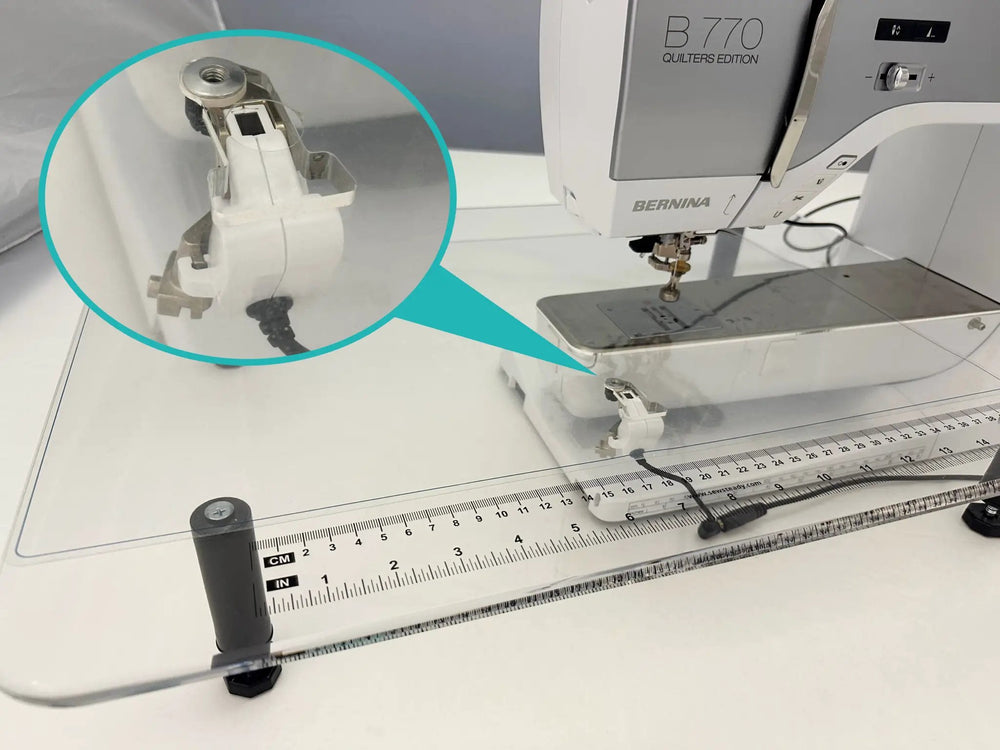Sew Steady Clear Stitch Regulator Glider attachment, white plastic with metal parts on a Bernina sewing machine.