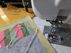 Sew Steady Clear Ruler Work Glider; clear acrylic grid rulers (A/B) beside a sewing machine