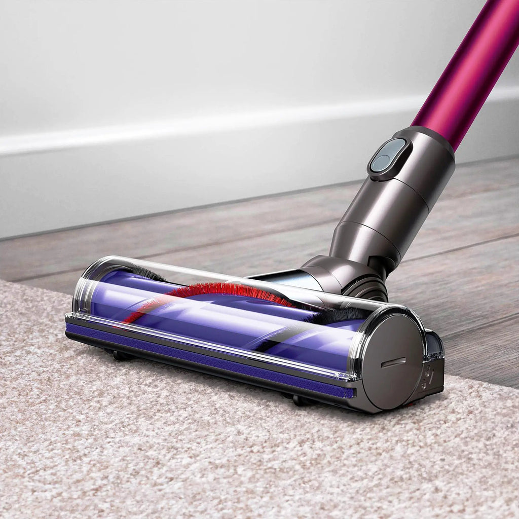 Dyson V6 Motorhead vacuum with purple wand and silver body on carpet