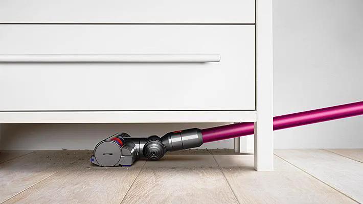 Dyson V7 Motorhead cordless vacuum with pink wand and gray body.