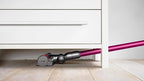 Dyson V7 Motorhead cordless vacuum with pink wand and gray body.