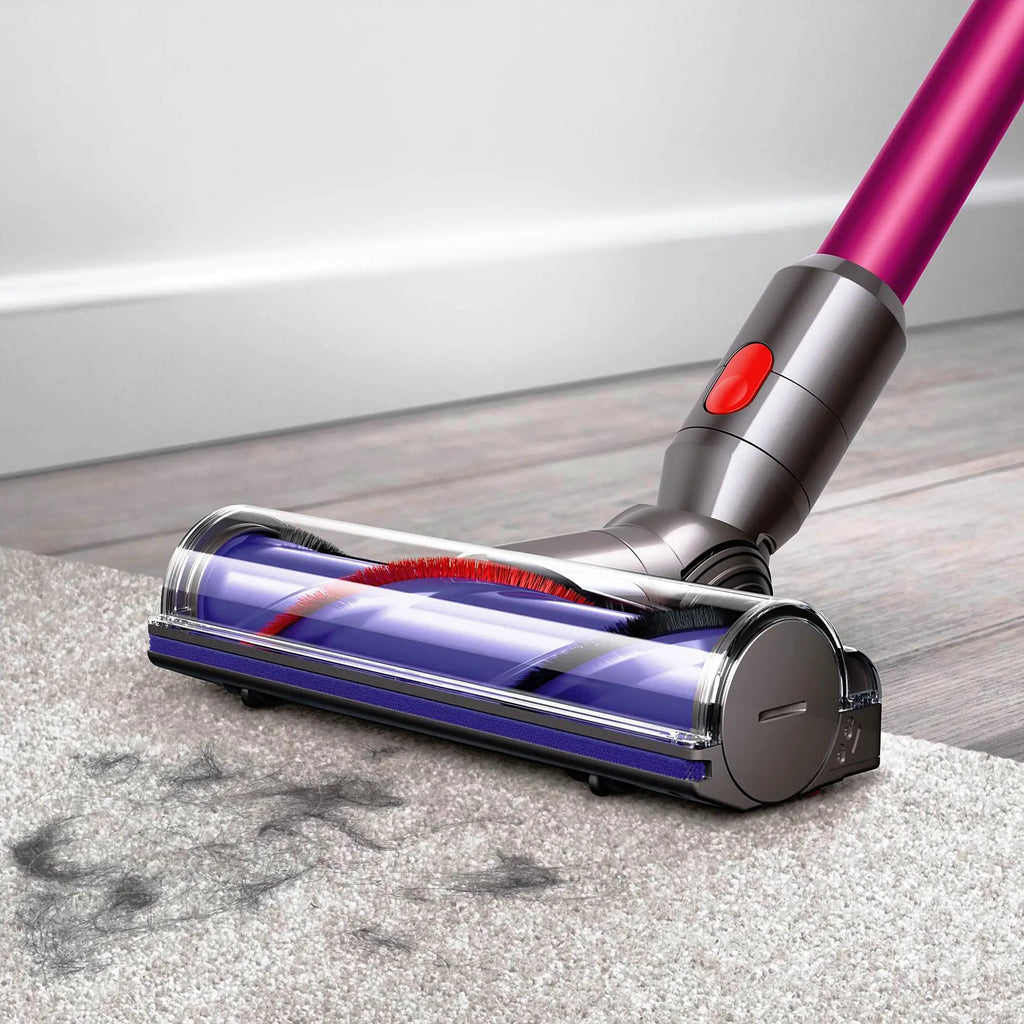 Dyson V7 Motorhead cordless vacuum with pink wand and red control button.