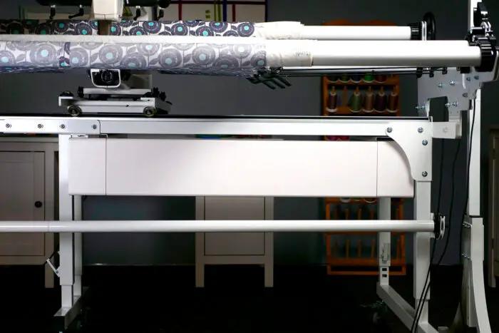 HQ My Secret Drawer quilting frame accessory by Handi Quilter; white metal frame with fabric rollers.
