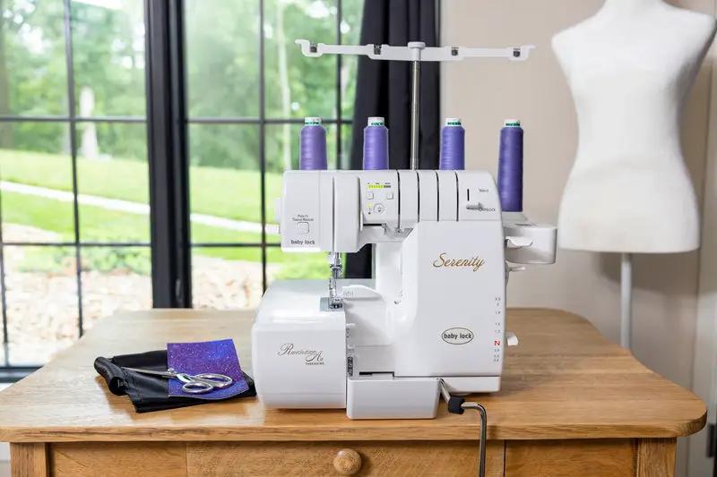 Baby Lock Serenity 4-Thread Serger sewing machine with purple thread spools on a wooden table