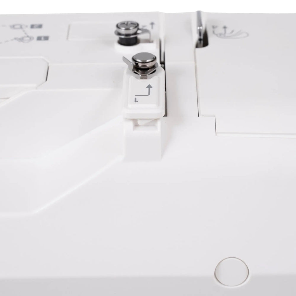 Janome SewSwitch 30 sewing machine; white body with metal presser foot and dials.