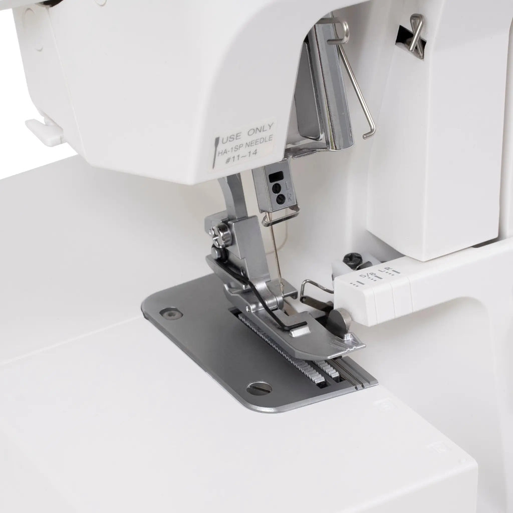 Janome SewSwitch 30 sewing & overlocker combo; close-up of needle, presser foot and stitch plate