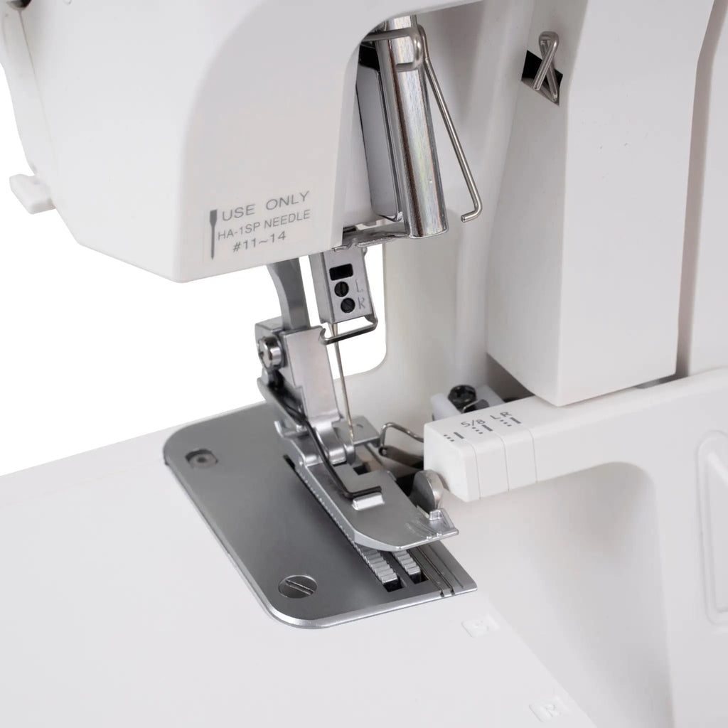 Janome SewSwitch 30 serger sewing machine; white body with metal presser foot and needle plate