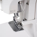 Janome SewSwitch 30 serger sewing machine; white body with metal presser foot and needle plate