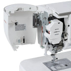 Janome Skyline 8 sewing and quilting machine, computerized, white exterior with open housing showing components.