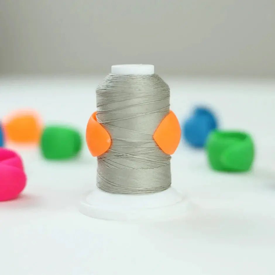 The Gypsy Quilter Thread Peels TGQ013 thread storage spool with gray thread and two orange clips