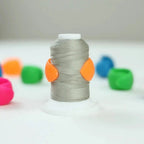 The Gypsy Quilter Thread Peels TGQ013 thread storage spool with gray thread and two orange clips
