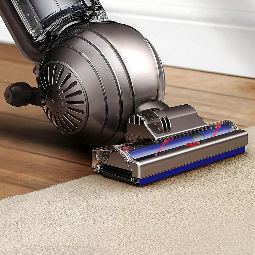 Dyson Cinetic Big Ball Animal + Allergy vacuum with metallic gray body and blue cleaning head on carpet